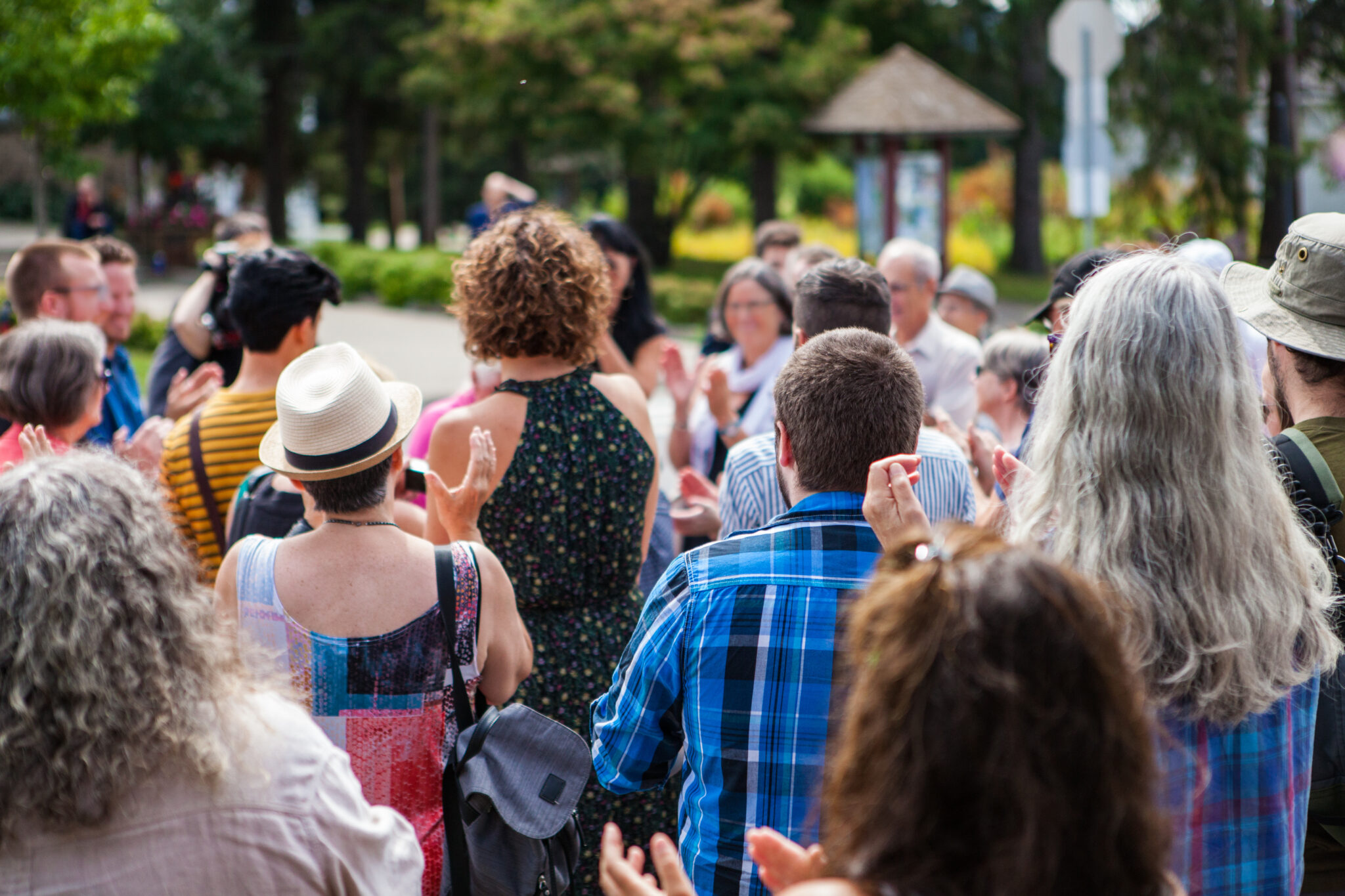 100 People applauding to a public speech given outdoors in the v