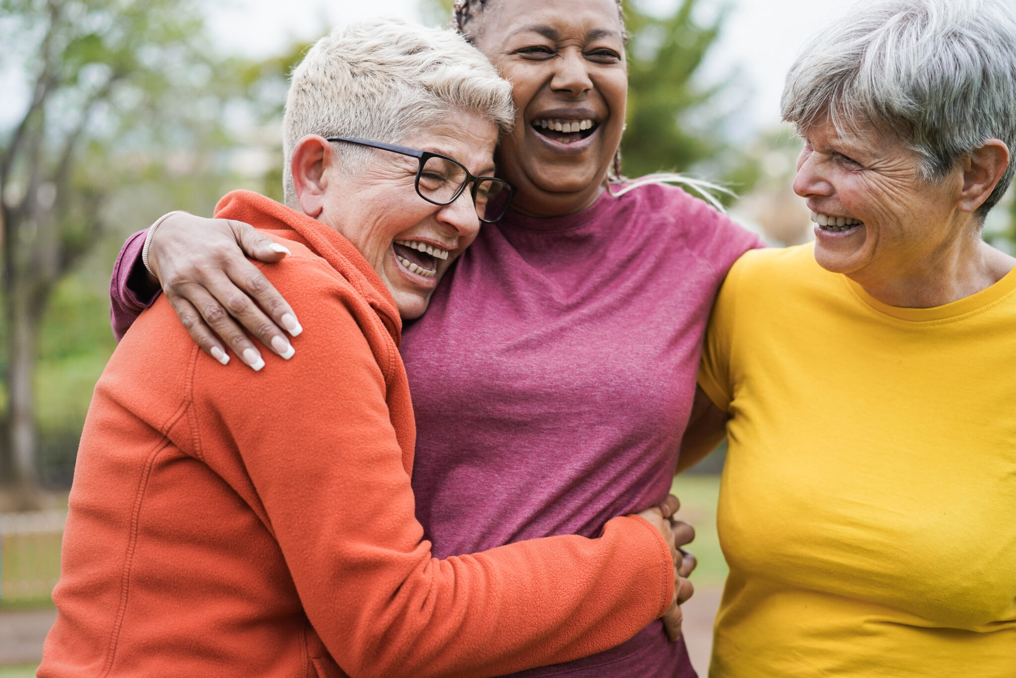 Multiracial senior women having fun together after sport workout outdoor - Main focus on right female face